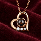 Close-up of the heart pendant's dark projection stone and three clear accent stones