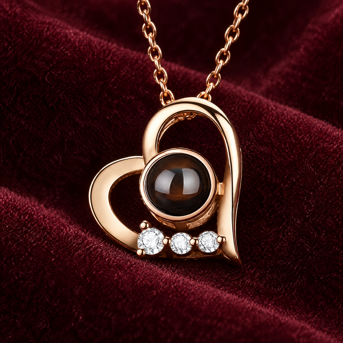 Close-up of the heart pendant's dark projection stone and three clear accent stones