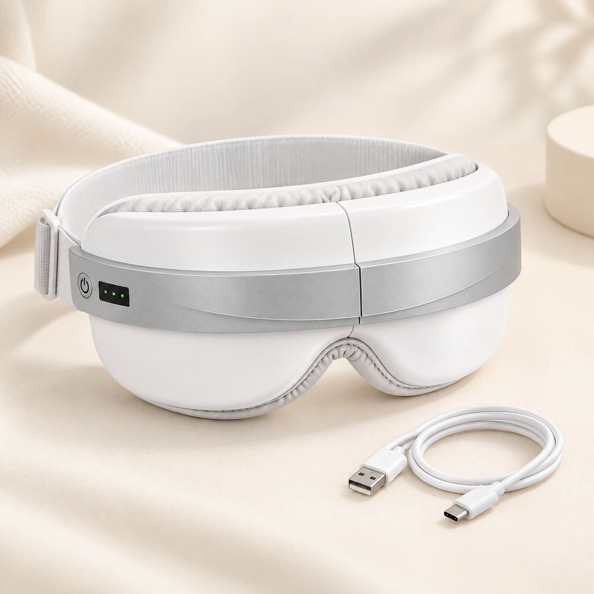 The eye massager with its USB cable.