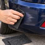 Hand rubbing out a light scuff on a bumper